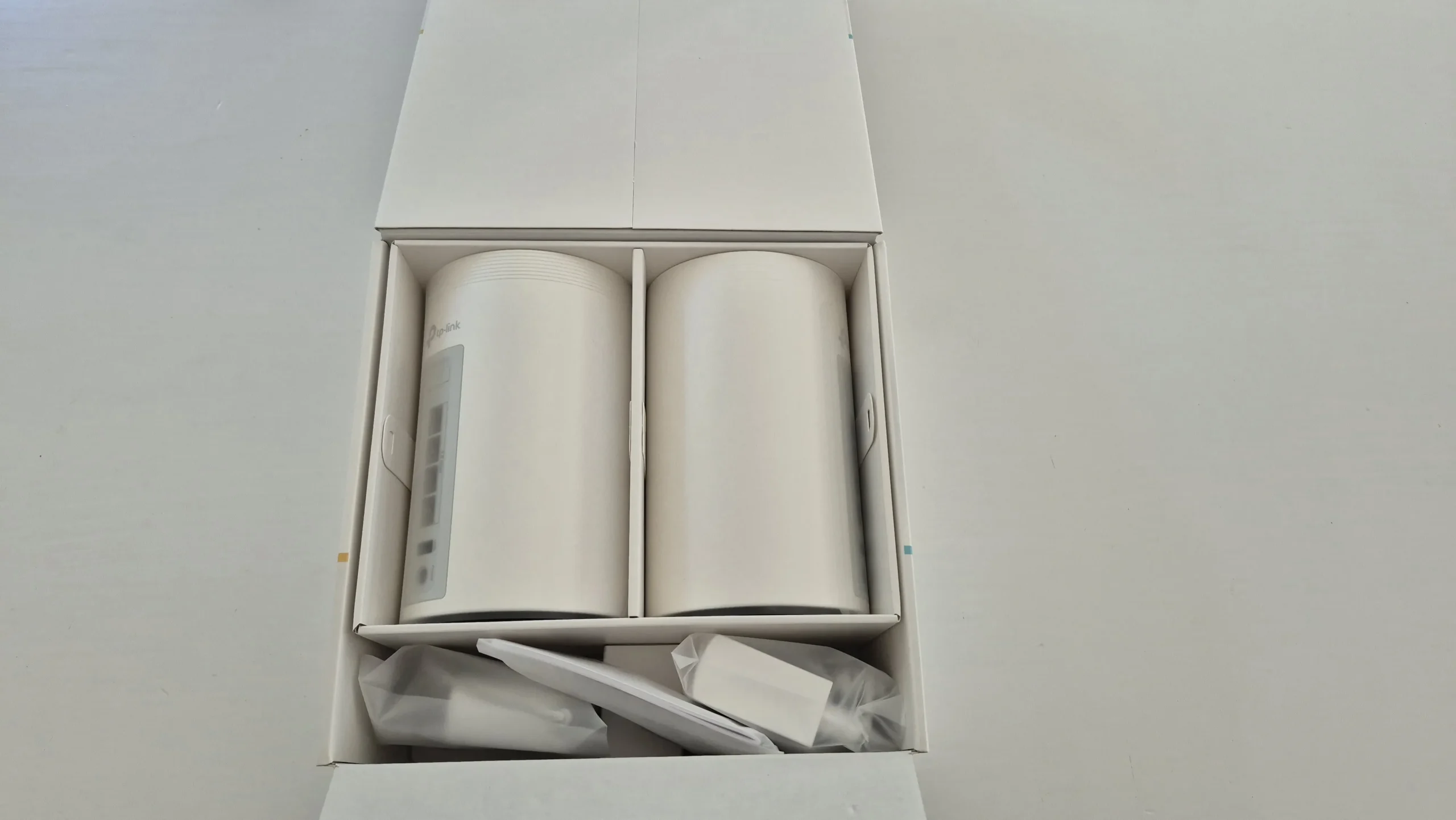The units and accessories inside the opened box.